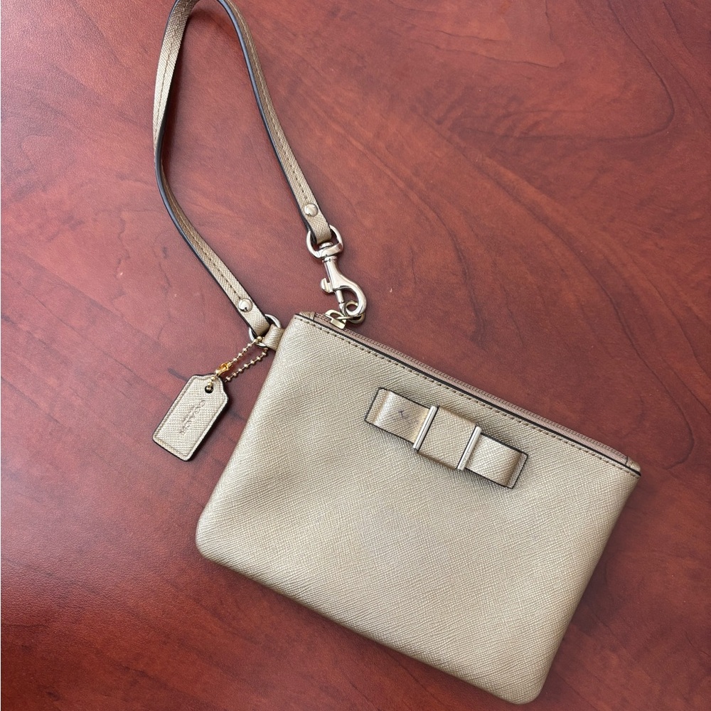 COACH Metallic Gold Bow Coated Canvas Wristlet